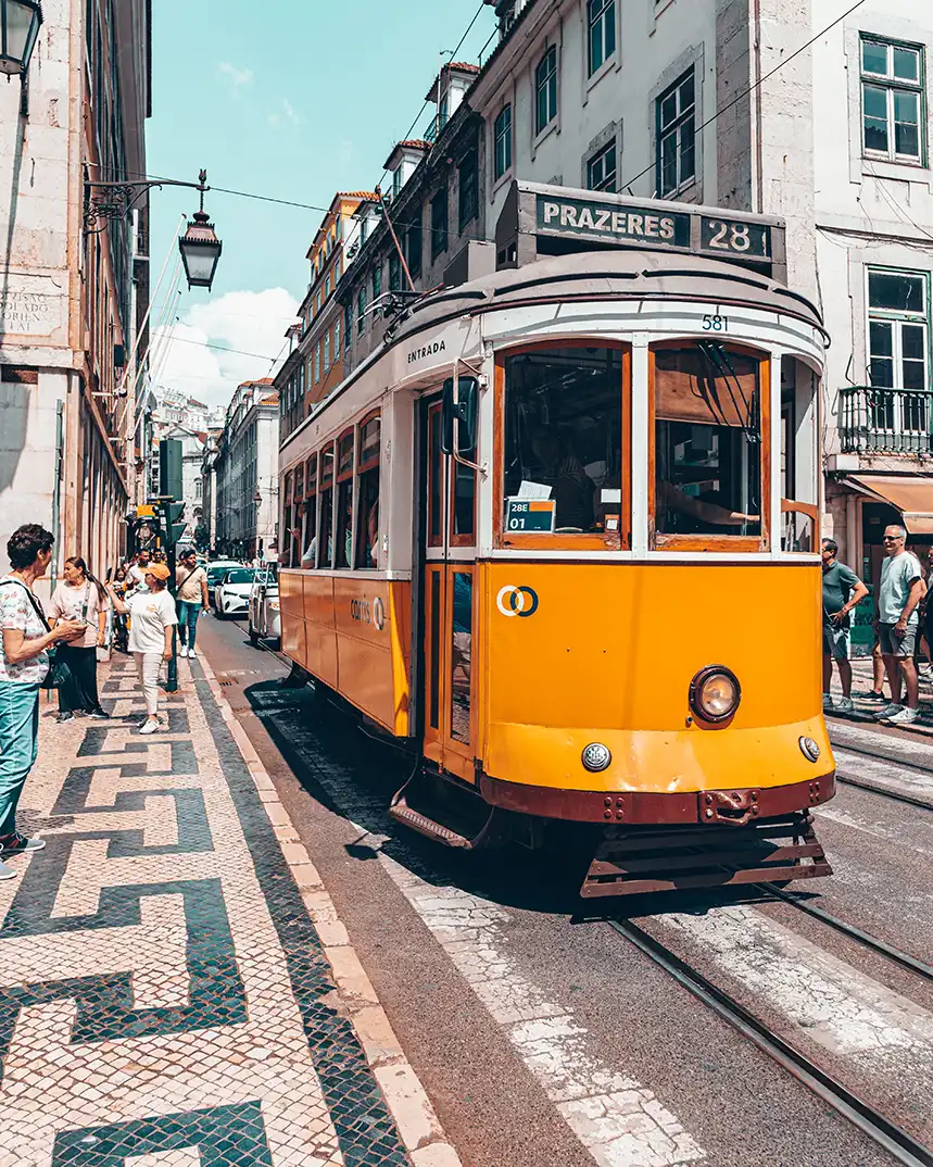 A Lisbon tram crossing a central city street on a European city break