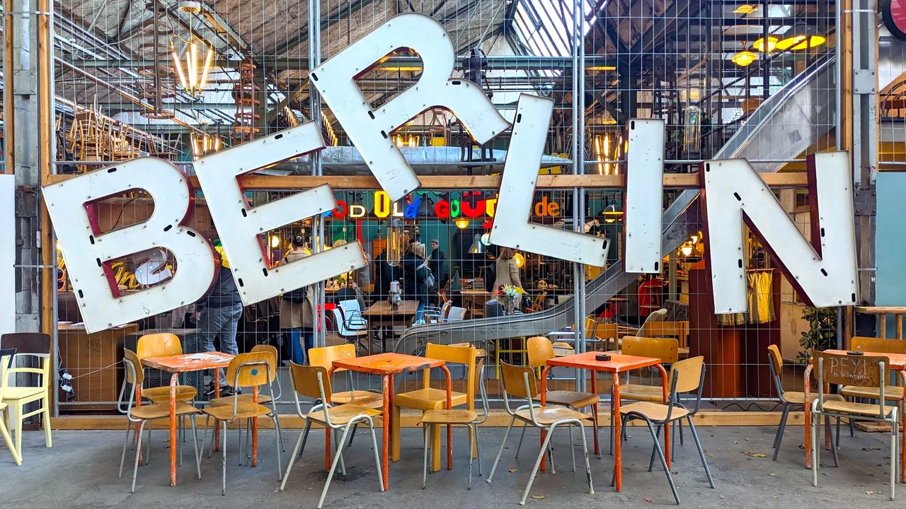 Large Berlin lettering above outdoor café tables