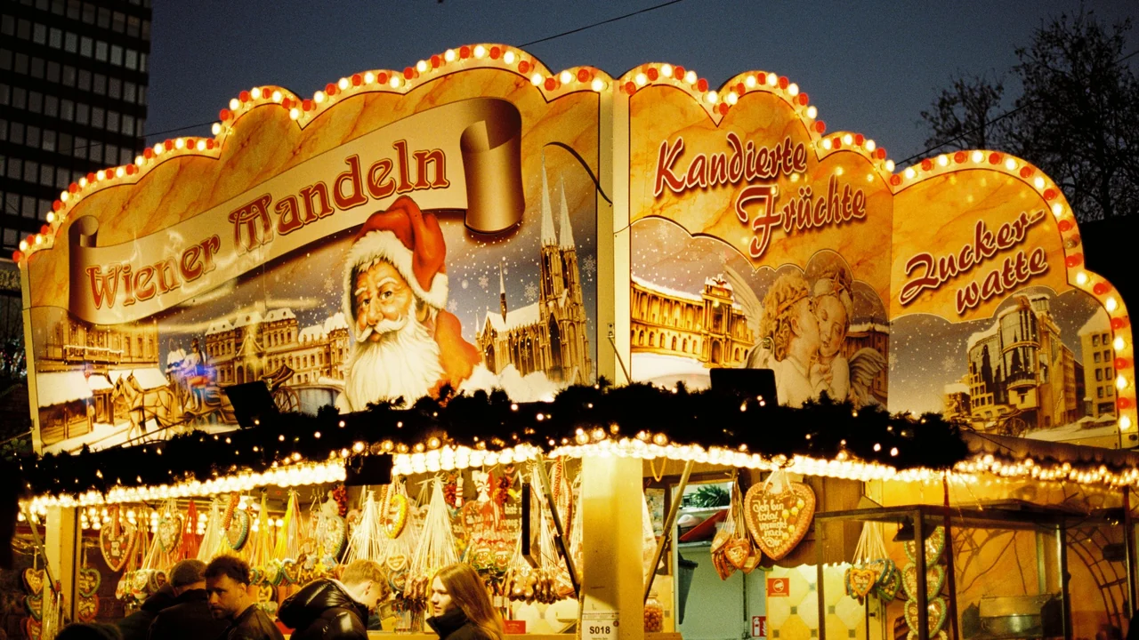Illuminated Christmas market stall selling nuts and festive treats in Berlin