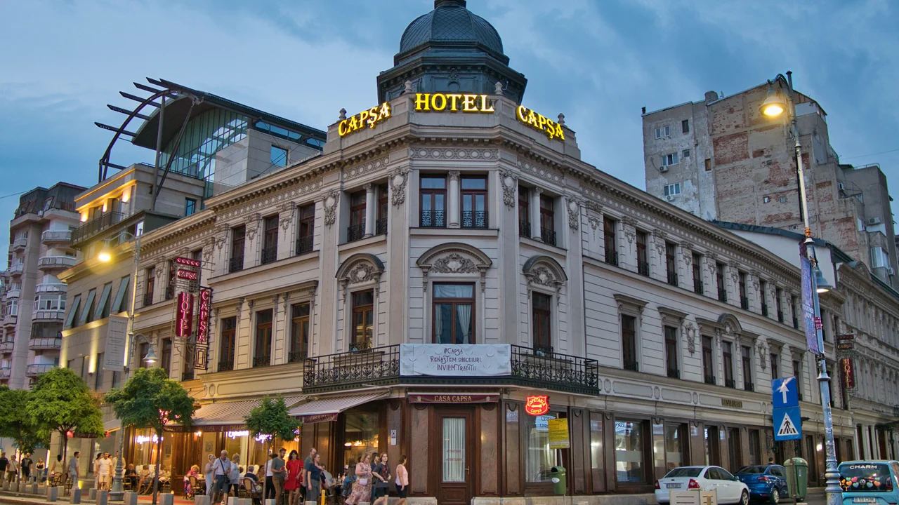 Historic Bucharest hotel and neighbouring buildings at dusk