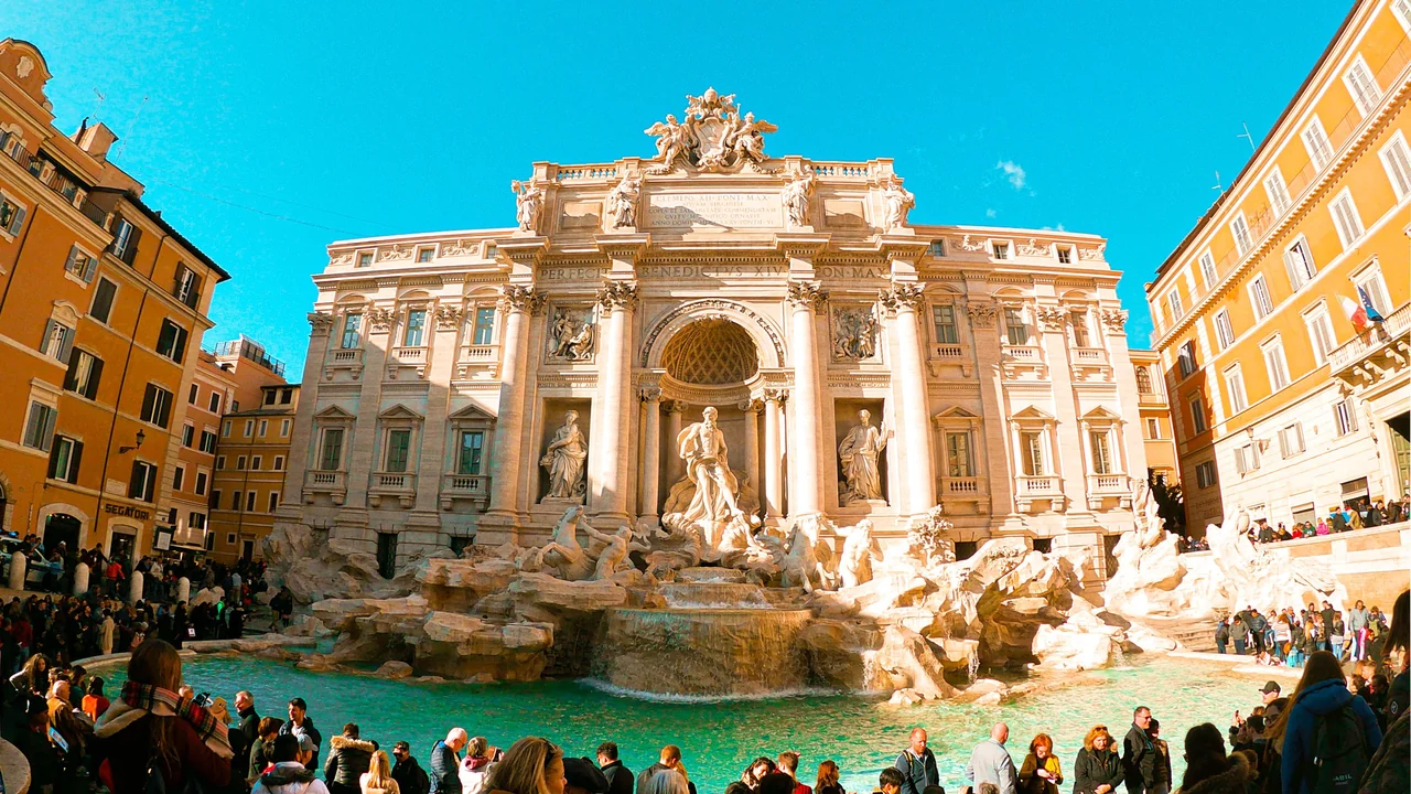 Rome’s Trevi Fountain surrounded by visitors and warm-coloured buildings