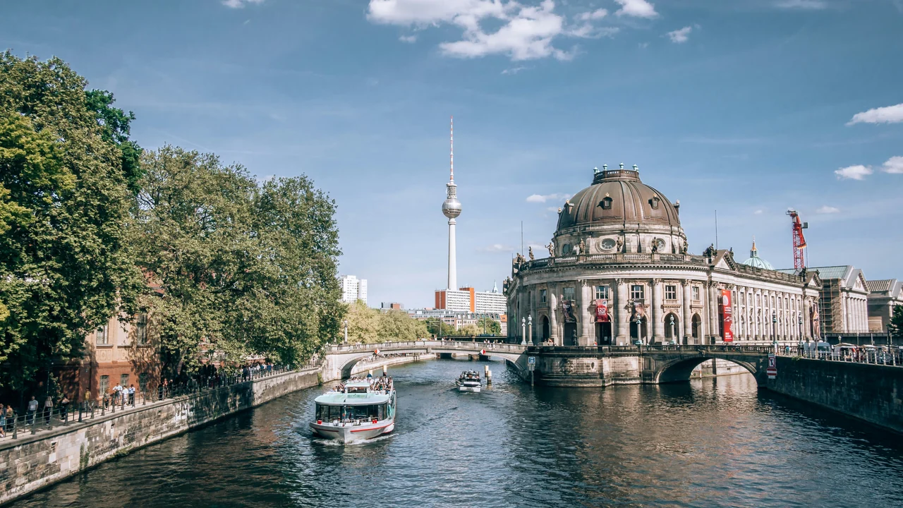 Berlin’s Bode Museum beside the River Spree, with a sightseeing boat and the TV Tower in the distance