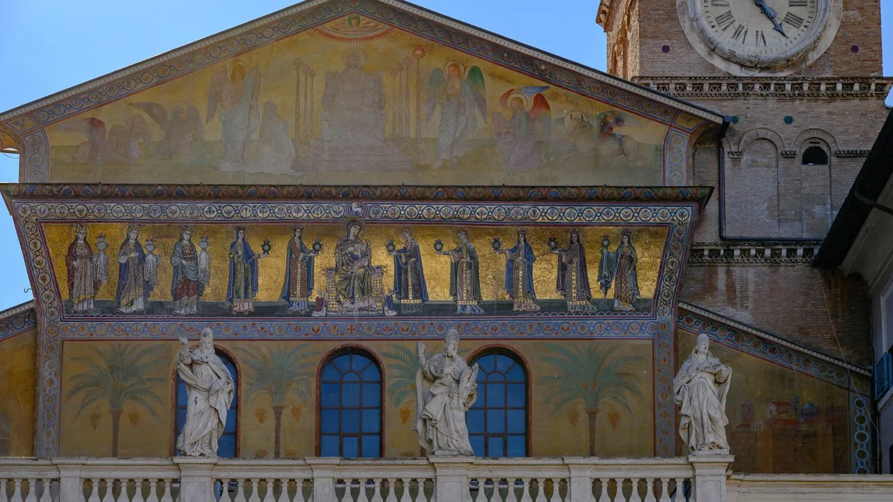 Mosaics, statues and clock on Santa Maria in Trastevere in Rome