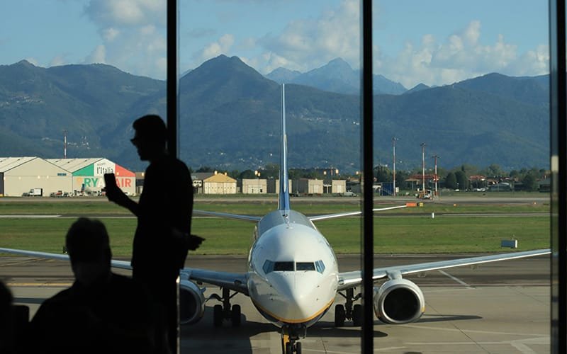 a man standing next to a plane