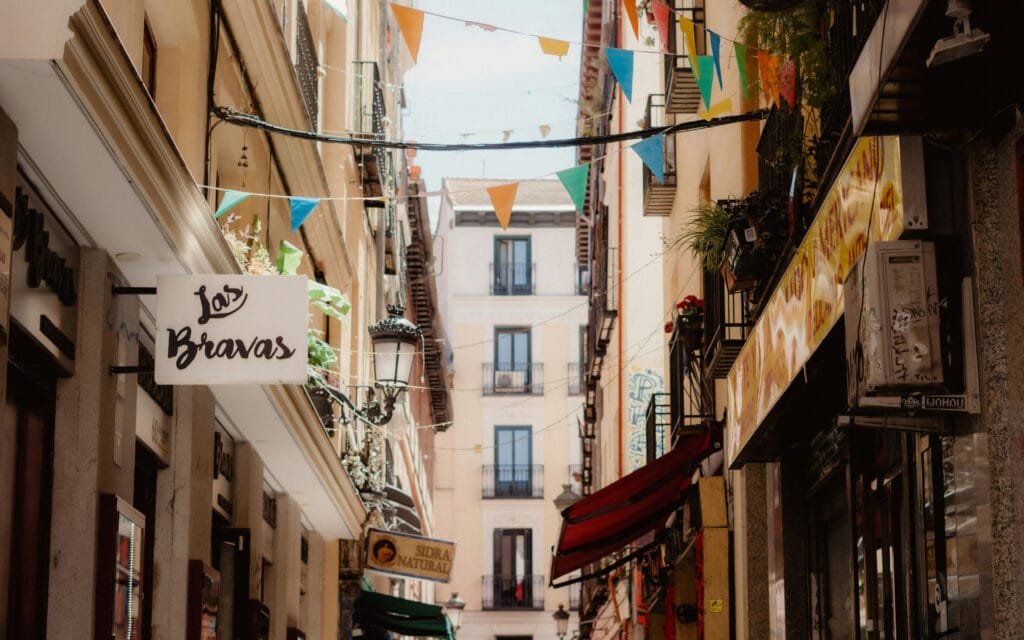 Madrid City Breaks - a street with flags and signs