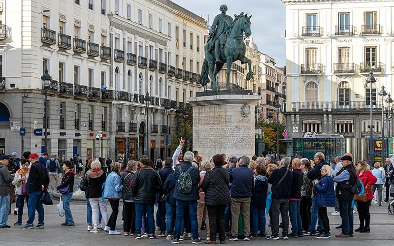 a group of people standing in front of a statue