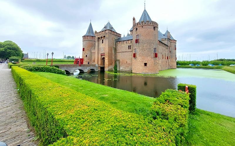 a castle with a body of water and a bridge