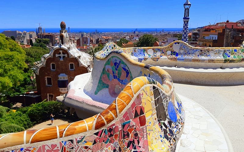 a colorful mosaic bench in a park