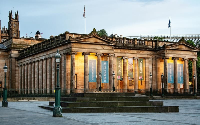 a building with columns and flags