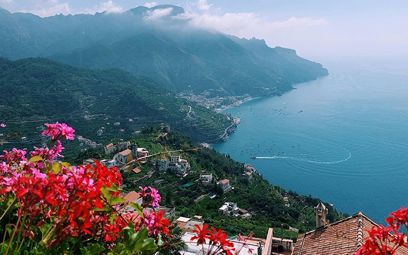 a view of a town and a body of water from a hill