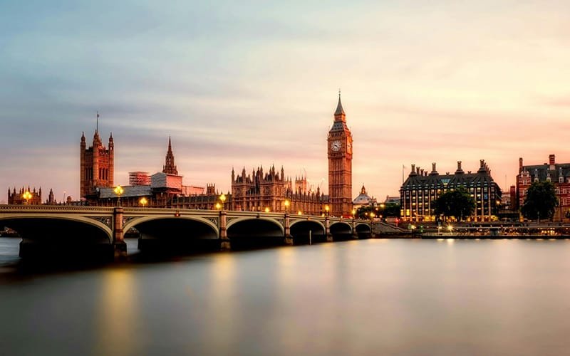 london bridge over a river with a clock tower and buildings