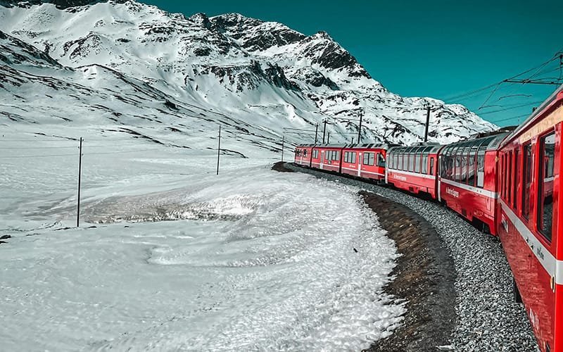 a train on the tracks in the snow