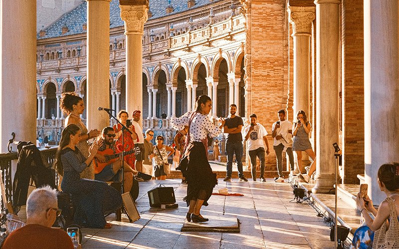 a woman performing on a stage with people in the background