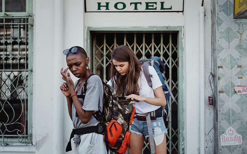 a woman looking at a backpack