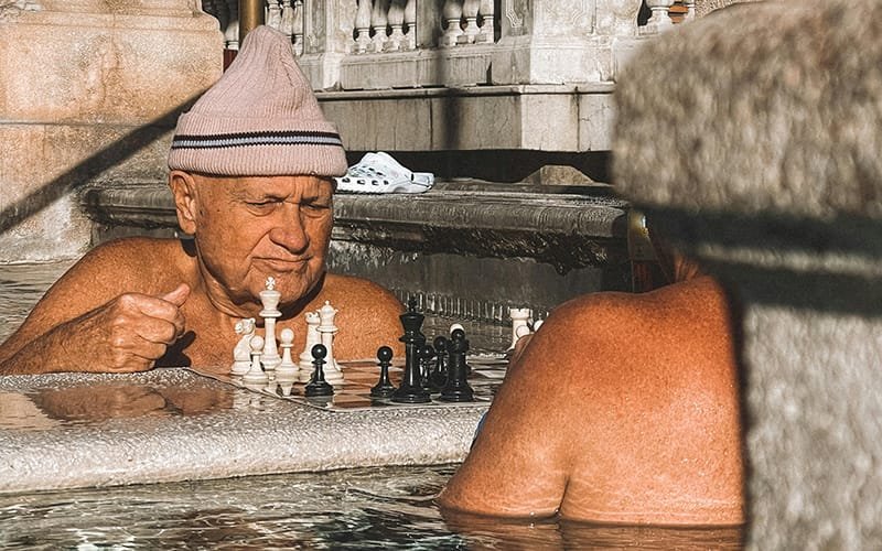 two men playing chess in a pool thermal pool