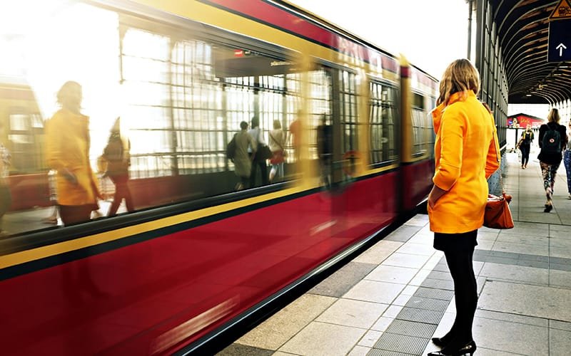 a woman standing at a train station