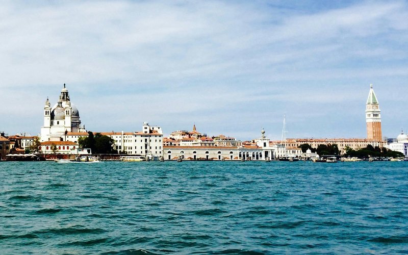 holidays in Italy - body of water with buildings and a tower