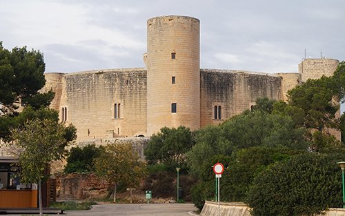 a large stone building with trees around it