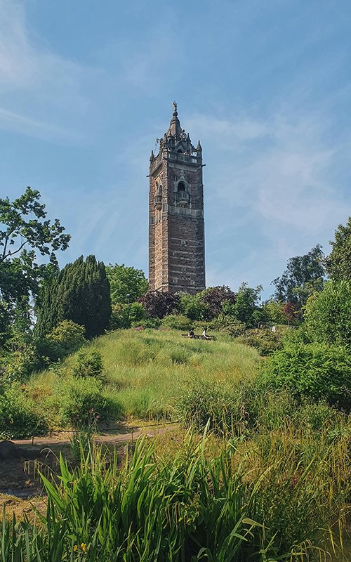 a tall tower on a hill with Cabot Tower, Bristol in the background